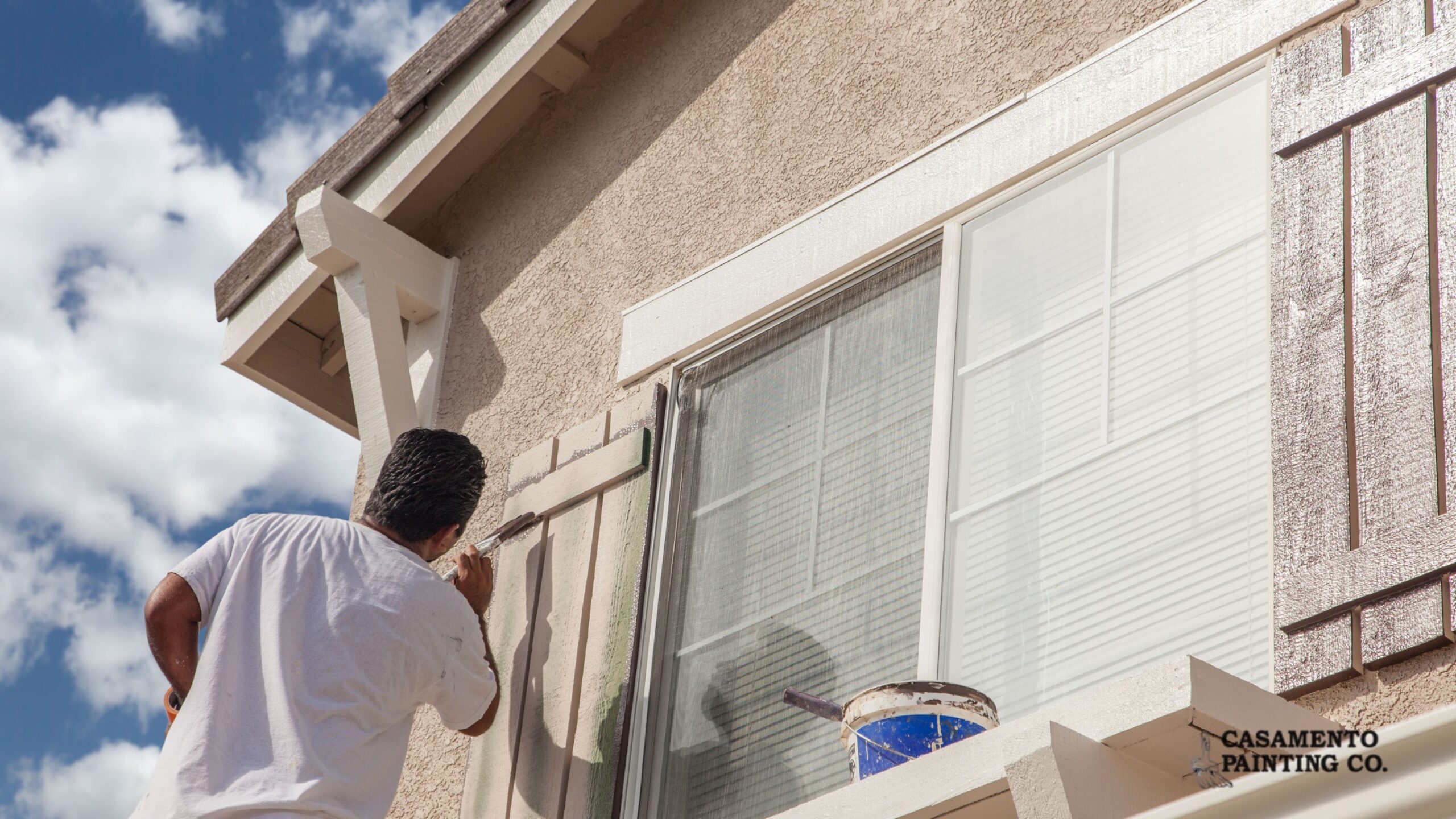 Professional exterior residential painter in Illinois applying fresh paint to a home exterior by Casamento Painting